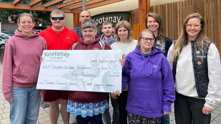 Students and instructors in the SOAR Program accept a big cheque from the Kootenay Co-Op grocery store