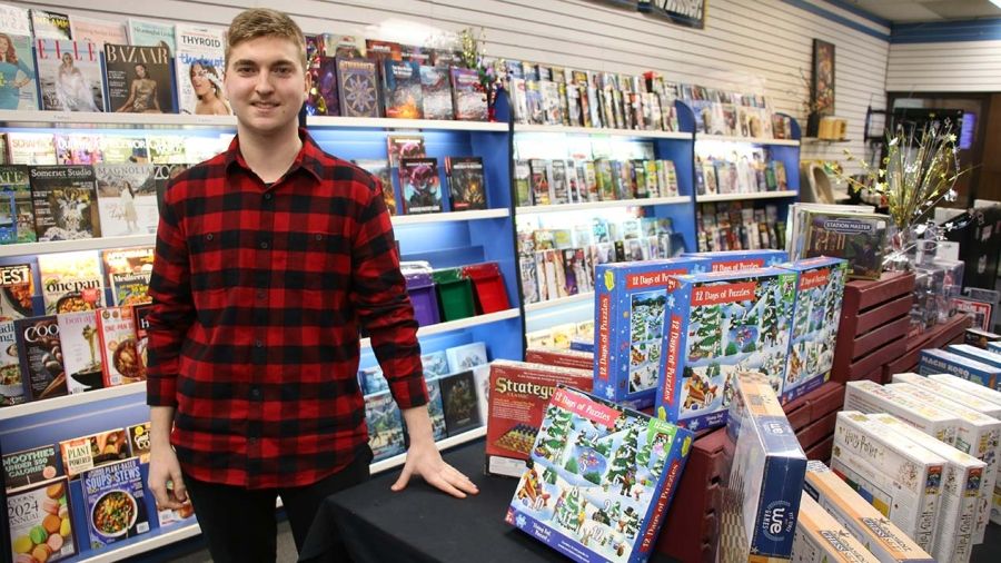 Business Adminstration Program student Brady Stocks in his shop with puzzles and magazines