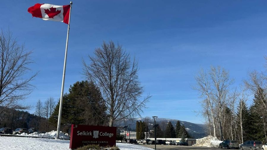 The Selkirk College Castlegar Campus sign and a Canadian flag