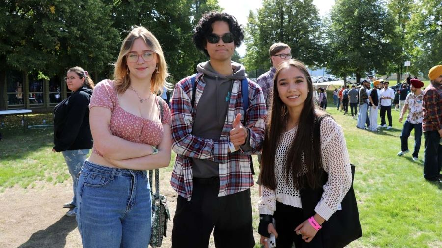 Three students stand outside at orientation